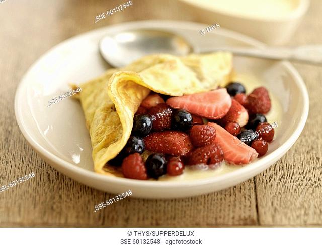 Omelette filled with summer fruit and vanilla custard