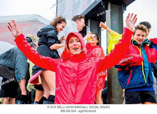 A short burst of heavy rain makes some people seek cover, others put their wellies and ponchos to good use. The 2015 Glastonbury Festival, Worthy Farm