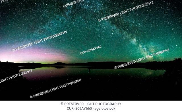 Milky way and aurora borealis over ellis reservoir, Penticton, British Columbia, Canada