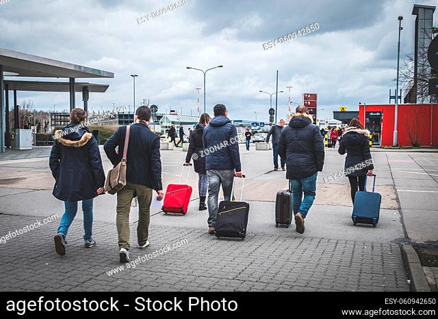 Berlin, Germany - march 2019: People with luggage walking at airport, travel concept -