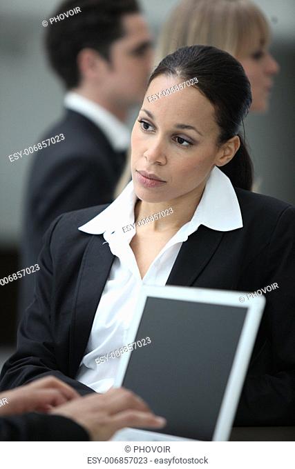 Female executive working with colleague at a laptop