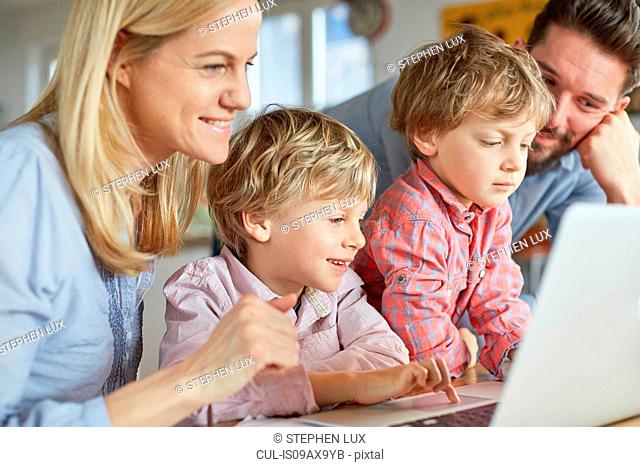 Parents and sons using laptop