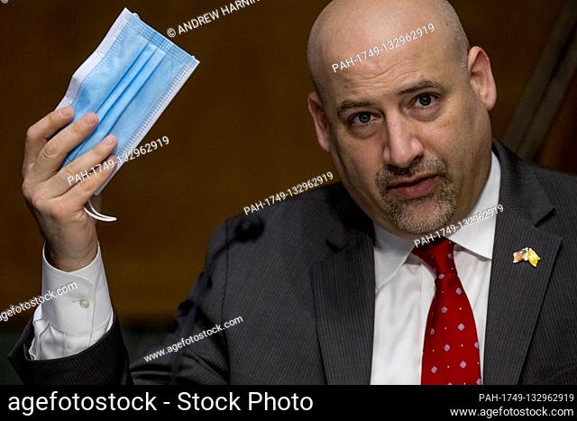 Justice Department United States Attorney Craig Carpenito holds up a face mask as he speaks during a US Senate Judiciary Committee hearing on Capitol Hill in...