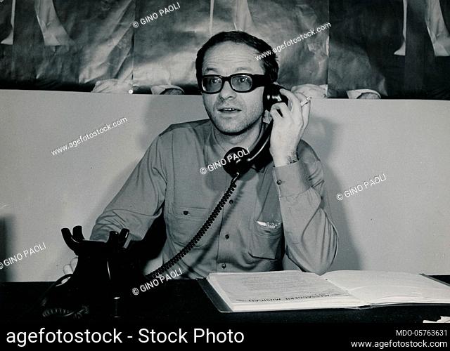 Italian singer-songwriter Gino Paoli talking on the phone. 1960s