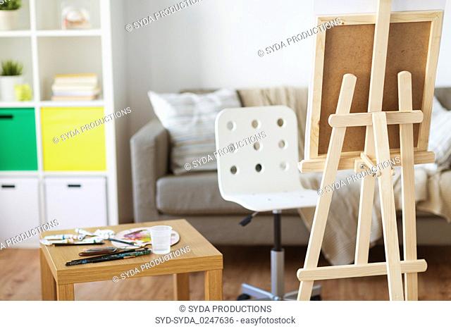 easel and artistic tools at home or art studio