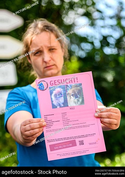 22 June 2020, Hessen, Wiesbaden: Nadine Bernardy, head of the animal shelter Wiesbaden, holds a profile of Pekinese ""Mili"", who was stolen from the shelter