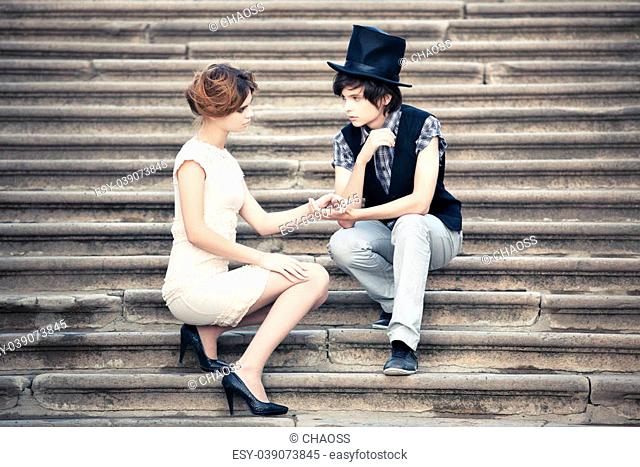 Young elegant couple on a stone stairs