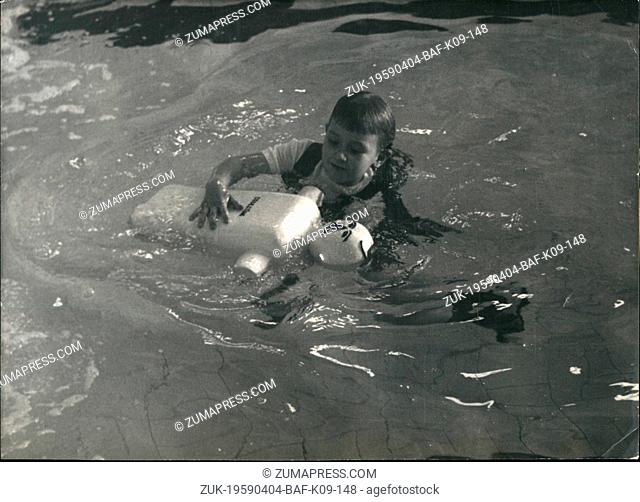 Apr. 04, 1959 - Five-year-old swimmer 'saves' doll from drowning: swimming val in a Paris pool: A swimming festival was held at the Ledru rollin, Paris