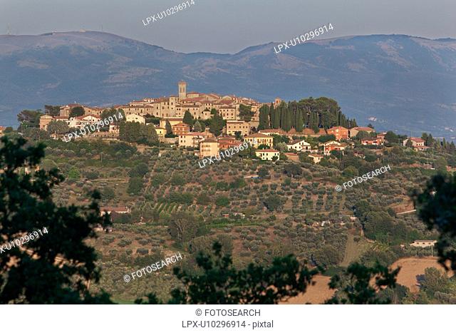 Medieval hilltop town of MonteCastello di Vibio at sunset, with background of hills beyond the Tiber valley, Umbria, Italy