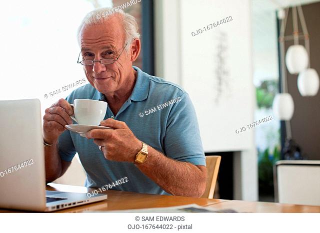 Older man having cup of coffee indoors