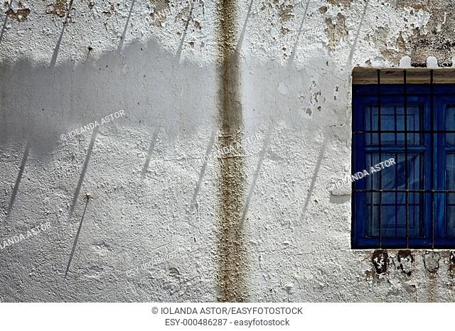 White wall and white window with bars  Fisherman's house in La Isleta del Moro, Parque Natural del Cabo de Gata, Andalusia, Spain