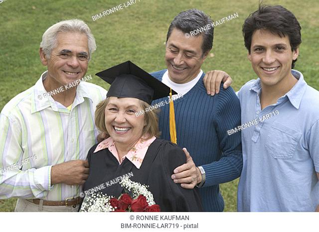 Older graduate posing with family