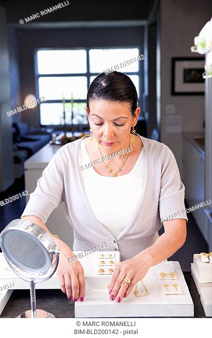 Hispanic woman working in jewelry store