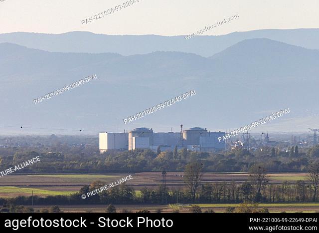 PRODUCTION - 05 October 2022, Baden-Württemberg, Heitersheim: The French nuclear power plant Fessenheim stands in the evening light while the French Vosges...