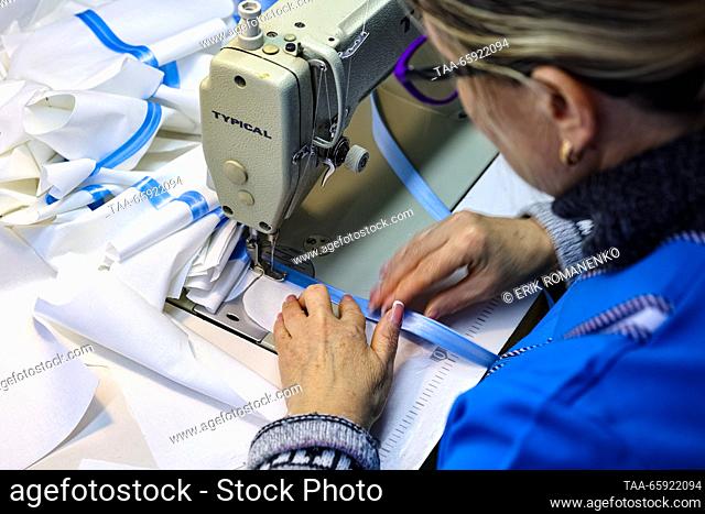 RUSSIA, VORONEZH - DECEMBER 19, 2023: An employee manufactures dolls clothes at the Igrushki factory. The enterprise is engaged in production of PVC plastisol...