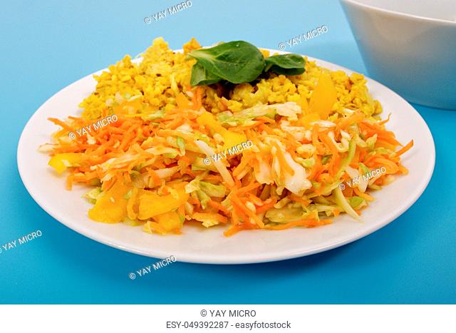 Baked Bulgar with cauliflower and vegetable salad on a blue background