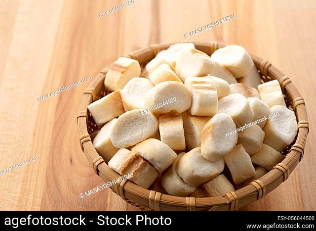 Japanese wheat gluten in a colander set against a wooden background