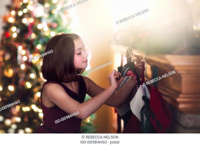 Young girl looking at christmas stocking