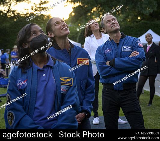 NASA astronauts Stephanie Wilson, left, Jasmin Moghbeli, and Tom Marshburn, along with Vice President Kamala Harris watch a video screen as NASA astronauts...