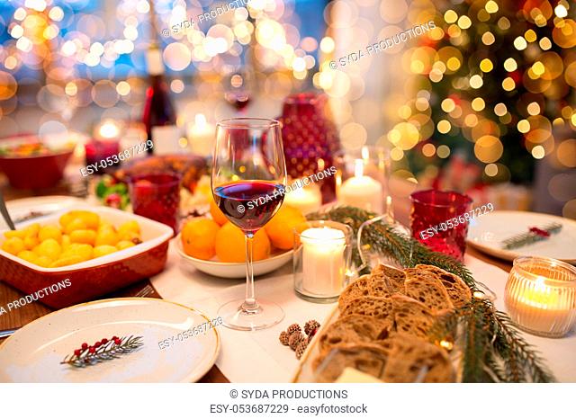 glass of red wine and food on christmas table