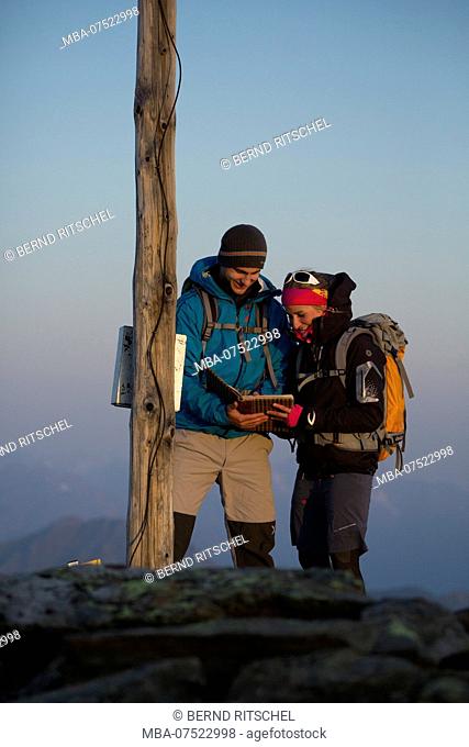 Mountaineers on the summit of Grieskogel Mountain at dawn, Geigenkamm Range, Ötztal Alps, Tyrol, Austria