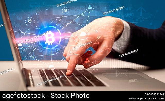Hand checking on laptop global bitcoin exchange rate concept