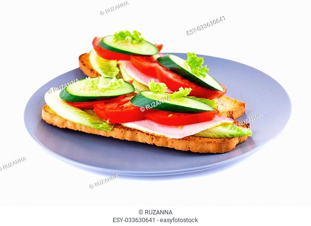 Rusk sandwiches with lettuce, tomato, cucumber and pork lion on plate isolated on white background