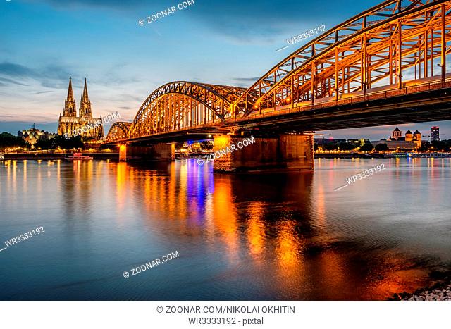 Night View of Cologne Cathedral (Kolner Dom) and Rhine river under the Hohenzollern Bridge, Cologne city skyline at night, North Rhine Westphalia region