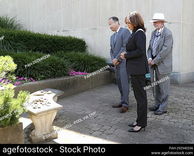United States Vice President Kamala Harris (C) and Second Gentleman Doug Emhoff (L) and Rabbi Jeffrey Myers (R) pause to reflect after laying stones at a...