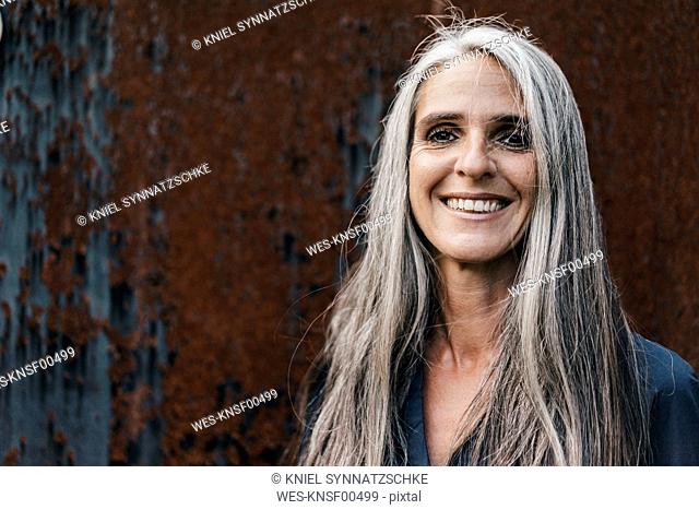 Portrait of smiling woman with long grey hair