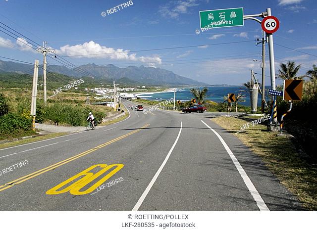 Cyclist on coast road in the sunlight, Highway No 11, Wushihbi, Republic of China, Taiwan, Asia