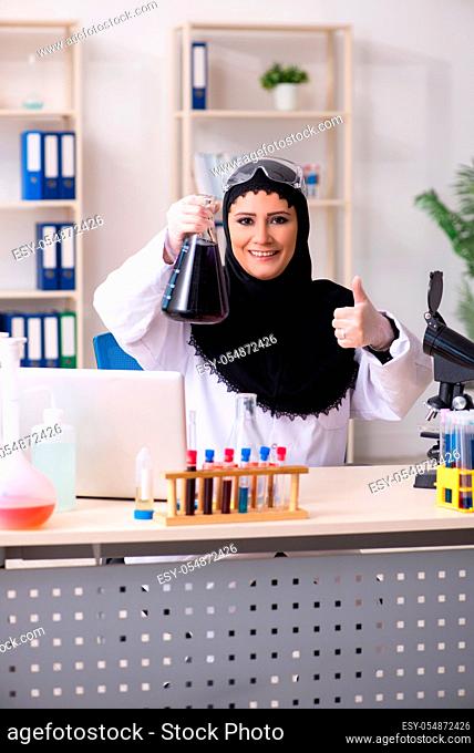 Female chemist in hijab working in the lab