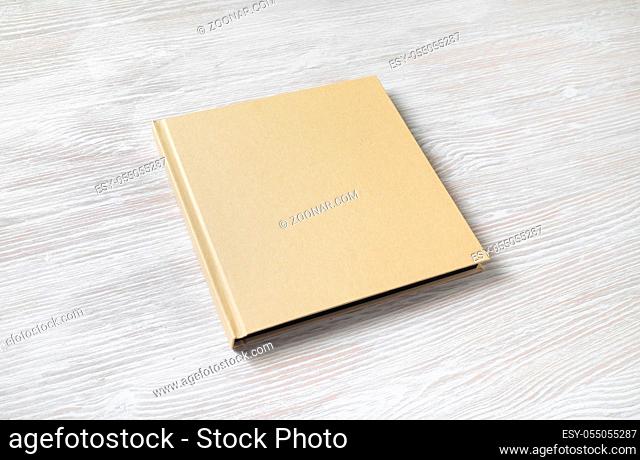 Blank square cover book on light wooden background
