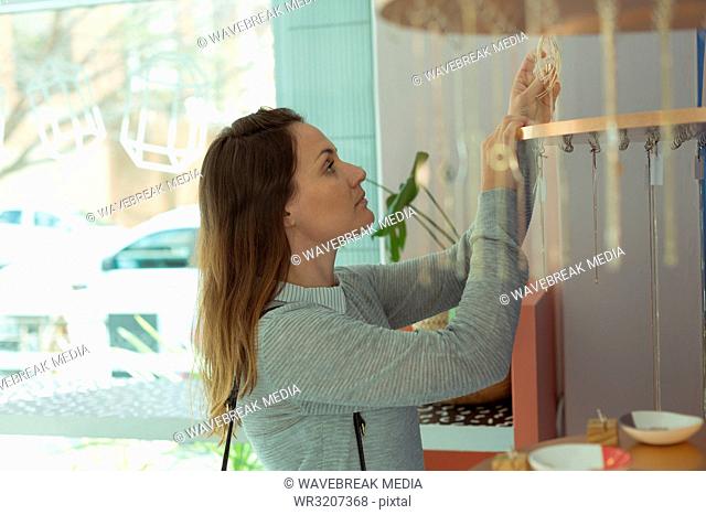 Female customer looking at jewelry in boutique shop