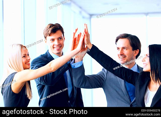 Successful business people celebrating giving high five