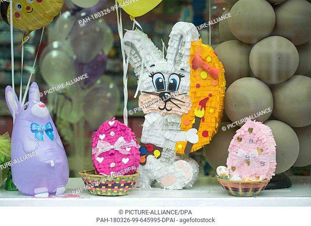 26 March 2018, Germany, Berlin: Pinatas on offer in a decoration shop. Pinatas are papier mché toy figures filled with candy and are traditionally hung during...