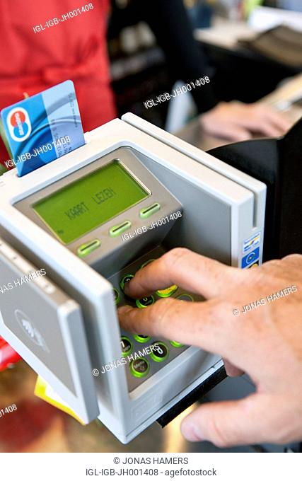 ATM machine and a Maestro credit card during a payment in a supermarket