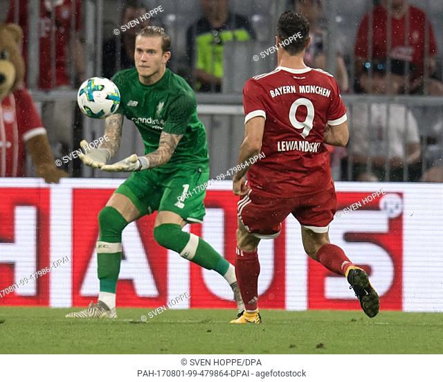 Bayern Munich#s Robert Lewandowski (R) and Liverpool goalkeeper Loris Karius vie for the ball during the Audi Cup semi-final pitting FC Bayern Munich vs FC...