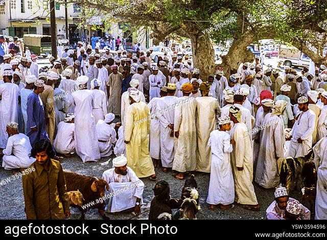 Local people crowd around the vendors at the old open-air souk (market) in Nizwa, Oman, 1984. A new market has since been built