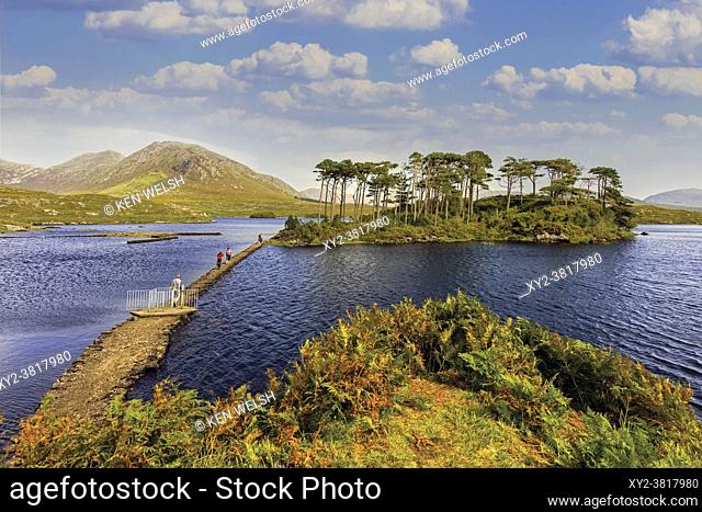 Visitors on causeway to Pines Island in Derryclare Lough, Connemara, County Galway, Republic of Ireland. Eire