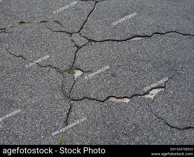 cracked black tarmac texture useful as a background