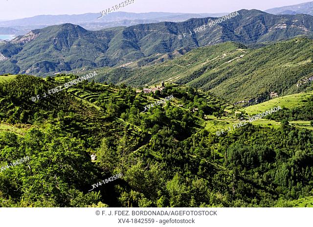 Panoramic views of Bestue village and agricultural terraces in front of Ordesa & Monte Perdido National Park, Huesca Pyrenees, Aragon, Spain
