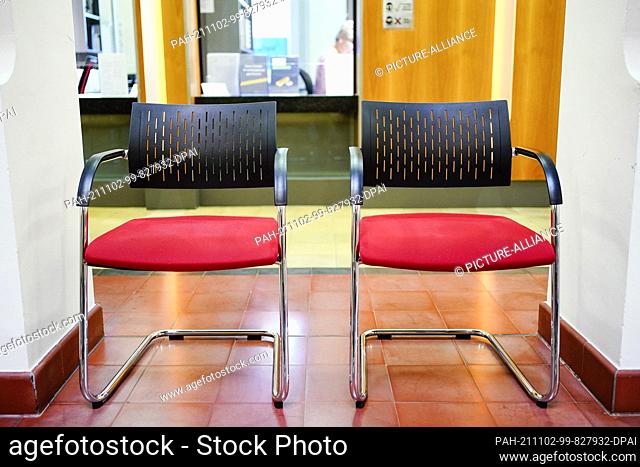 PRODUCTION - 27 October 2021, Baden-Wuerttemberg, Mannheim: Two empty chairs stand in the pawnshop waiting area in front of a customer counter