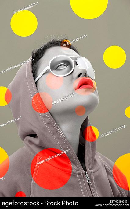 Art collage with close up fashion portrait young beautiful woman in hoodie and white strange glasses with eye. Alternative funky girl