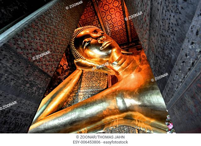 gold Reclining Buddha statue face. Wat Pho, Bangkok, Thailand