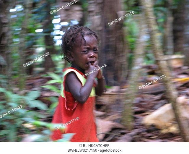 little boy in rural area, scared, crying and running away from photographer, Haiti, Grande Anse, Jeremie