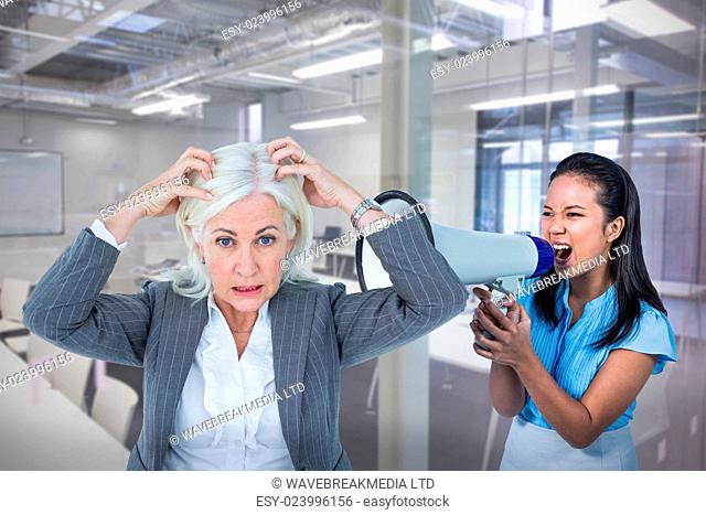 Portrait of stressed businesswoman with hands on head against classroom
