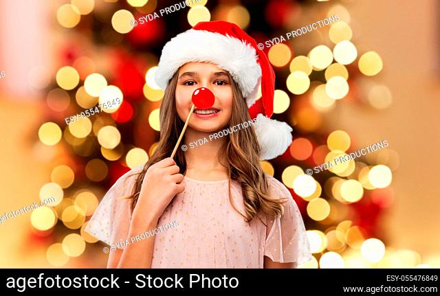 happy teenage girl in santa hat on christmas
