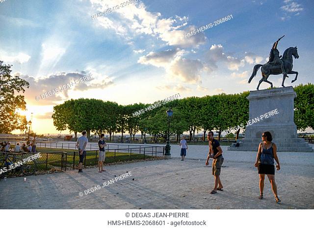 France, Herault, Montpellier, Place of Peyrou, petanque players in a park at day fall with a background sculpture