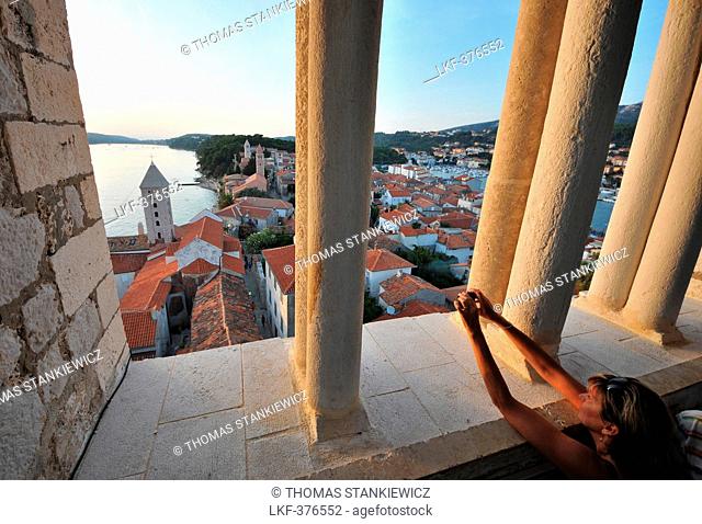 Woman taking a photograph, view from the tower of St. Andriji over the town of Rab, Rab Island, Kvarnen Gulf, Croatia